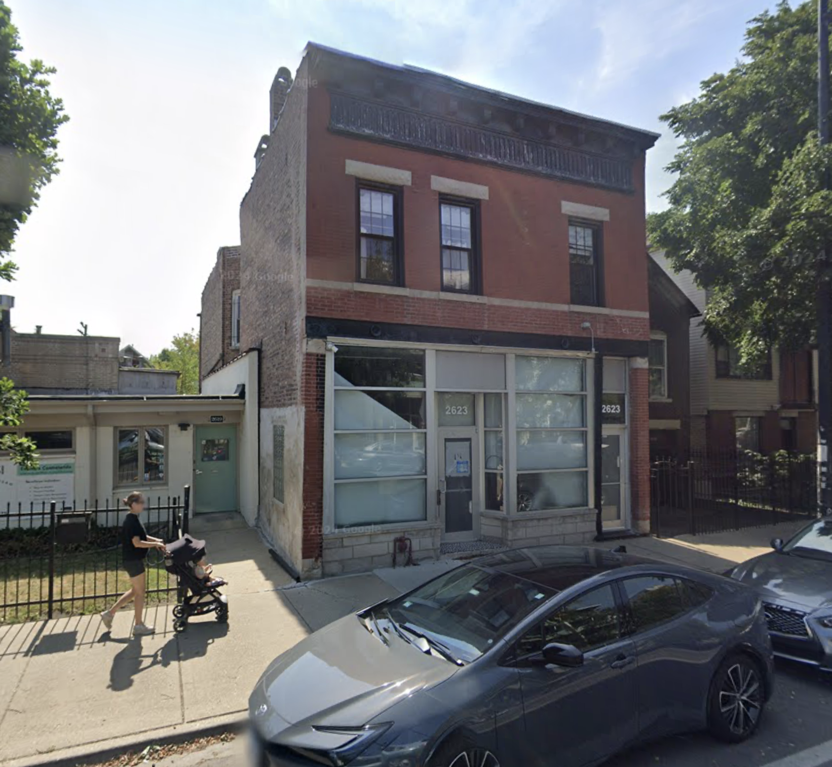 a two-story mixed-use building on Armitage Avenue in Logan Square that is on a block that has mostly ground floor residential already