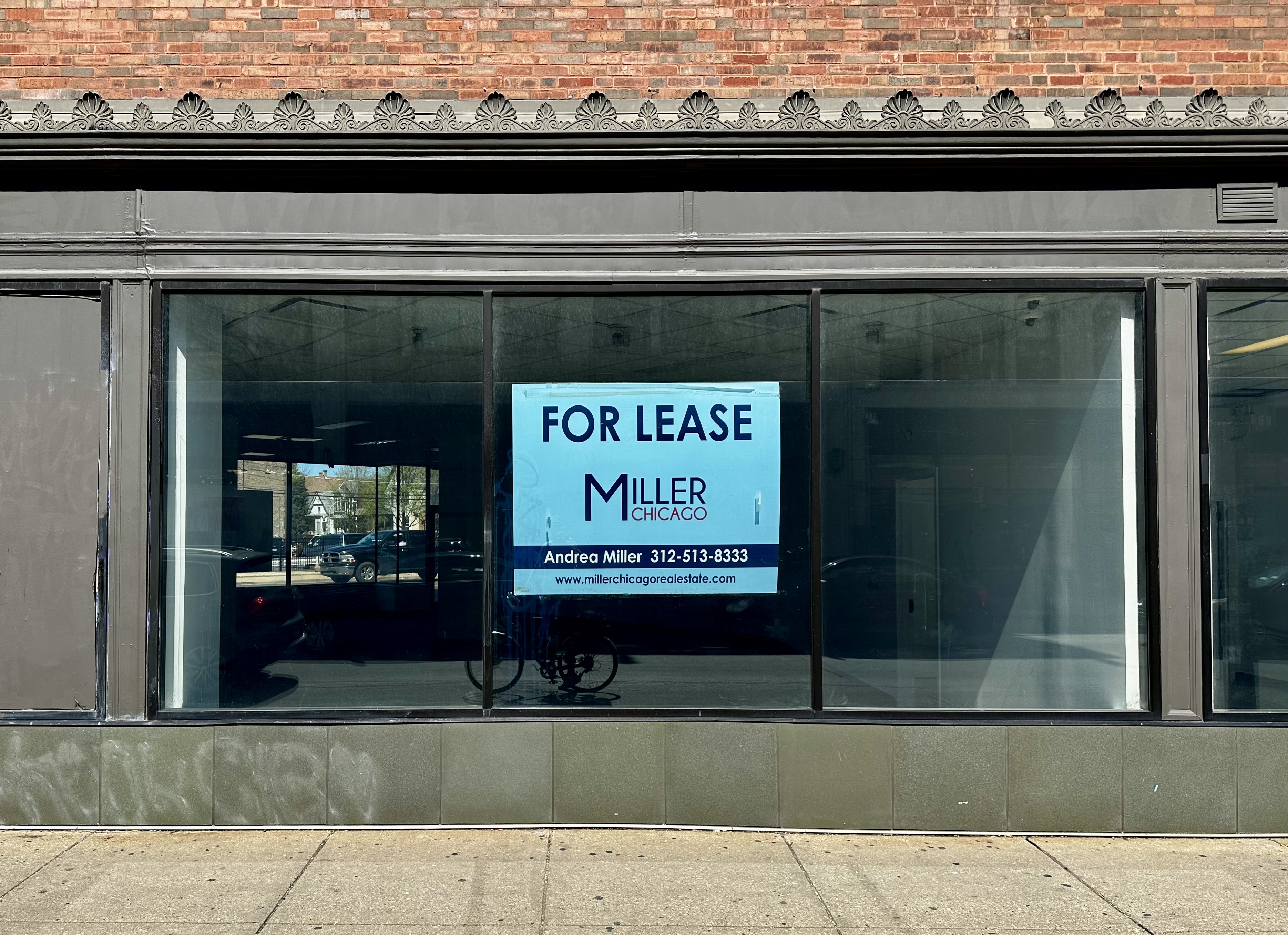 a storefront with a for lease sign in Logan Square